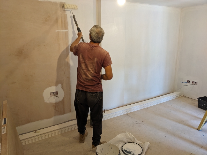Interior view showing the walls being painted.